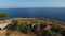 Top view of the Mamula fortress, rocky coast, seagulls flying over it, and the sea horizon