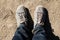 Top view of man foot with trekking shoes on ground floor background.