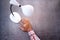 Top view of man hand turning lamp on black background