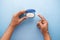 top view of man hand using petroleum jelly on blue background