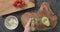 Top view man hands cut in halves and open ripe avocado on concrete countertop