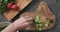 Top view man hands cutting fresh cucucmbers on concrete countertop