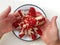 Top view of man hands holding a partially peeled pomegranate