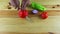 Top view on man hands by knife cut large red bell pepper on wooden table