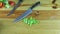 Top view on man hands organize wooden table with sliced green pepper and knives