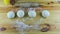 Top view on man hands put wooden rolling pin next to four small balls of yeast dough