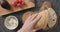 Top view of man hands slicing ciabatta bread on concrete countertop for making open sandwiches