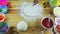 Top view on man by hands slowly making pizza dough round and thin on wooden table