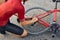 top view on man repairing bike. skilled athlete sportsman in t-shirt and shorts