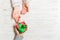 Top view of a man and a woman congratulating each other with a gift on wooden background. Surprise for a holiday concept. Copy