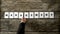 Top view of manager hand arranging ten white cards with letters