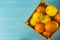 Top view. Mandarins and lemons in a wooden box with copy space for text. Fresh tangerines and lemons on a wooden background.
