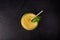 Top view mango lassi in glass with tube on dark background