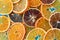 Top view of many dehydrated citrus fruits as lemons, tangerines, oranges on blue background