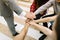 Top view of many hands showing unity on a light background. Office cooperation concept.