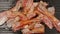 TOP VIEW: Many strips af bacon on a black pan
