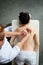 Top view of masseur massaging back and shoulder blades of young woman lying on massage table. Healing body massage at