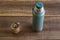 Top view of Mate caffeine-rich infused drink in a palo santo wood cup next to a thermos bottle