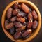 Top view of Medjool dates in wooden bowl, highly nutritious