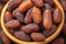 Top view of Medjool dates in wooden bowl, highly nutritious