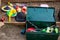 Top view of a metal box filled with toys and juggling equipment