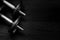 Top view of metal gym weights on wooden background. Black and white image.