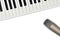 Top view of microphone and synthesizer keyboard on white background.