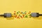 Top view of microphones with candies on bright and colorful background.