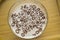 Top view of milk bowl, alphabet letters of cereal and chocolate flakes on wooden table, healthy Breakfast for kids and adults,