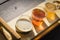 Top view mixed of draft beers in tasting sampler tray on wooden picnic table of brewery in Texas, USA