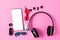Top view mobile device with mobile blank space for text,.accessories. micro USB Adapter, macro lens and headset on pink background