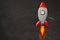 Top view mockup colorful drawing rocket on a blackboard backgroud with copy space. Flat lay