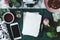 Top view on mockup of paper and smartphone on table with pink roses and cup of coffee