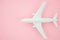 Top view model plane, close up airplane on pink pastel background. Flat lay with copy space for travel banner