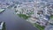Top view of modern city with river in center. Stock footage. Beautiful modern city with canal in center and lots of
