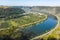 Top view on Mosel river valley and green terraced vineyards, Germany, production of quality white and red wine, riesling