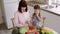 Top view of mother teach little preschooler daughter chop pepper preparing salad