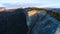 Top view of mountain landscape with green fields in evening sun. Shot. Beautiful mountain area with stone rock green