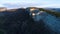 Top view of mountain landscape with green fields in evening sun. Shot. Beautiful mountain area with stone rock green