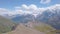 Top view of mountain pass with Observatory on background of snow peaks. Clip. Old Observatory is located in mountains