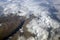 Top view of the mountain peaks of the Alps, covered by clouds or snow