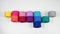 Top view of multicolored balls of cotton yarn on a white background. Stop motion.