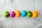 Top view of multicolored colorful Easter eggs over gray textured background with copy space.