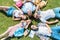 top view of multiethnic teenage classmates with books and backpacks lying together