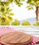 Top view napkin and pizza desk on wooden table with blurred park background, mock up