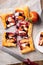 Top view of nectarine and blueberry puff pastry tart in portions