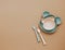 Top view neutral baby cute tableware on brown background,