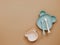 Top view neutral baby cute tableware on brown background, flat lay
