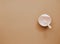 Top view neutral baby tableware on brown background, flat lay ,