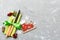 Top view of New Year dinner on cement background. Festive cutlery on napkin with christmas decorations and toys. Family holiday